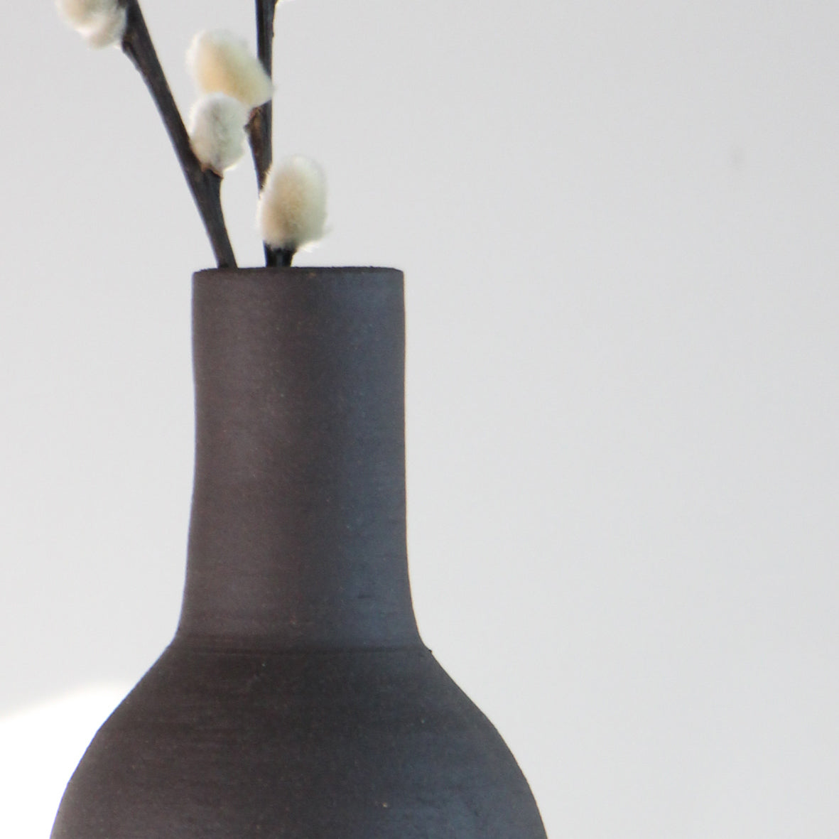 Home decor pottery. Brown clay vase from the Sardinia Wish Bottle collection, a handmade piece of home decor pottery inspired by the Mediterranean coastlines.